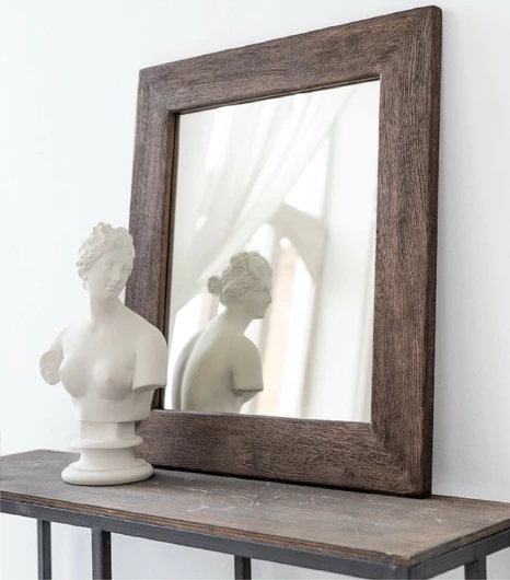 Close-up of a rustic wooden mirror frame